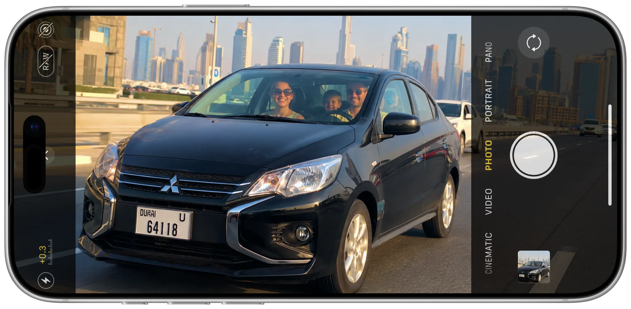 A family driving through Dubai in a YESSURE rental, framed on an iPhone camera